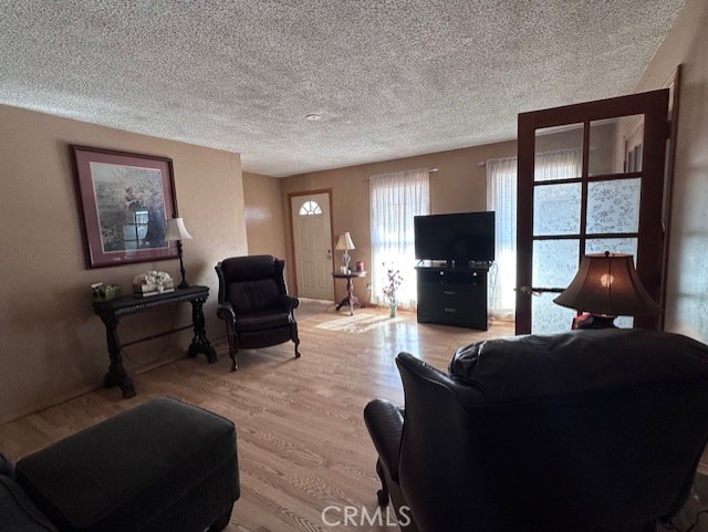 25478 Ash Road Barstow, CA 92311 - Photo 6 of 35 a living room with furniture a flat screen tv and a fireplace