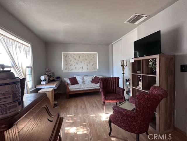 25478 Ash Road Barstow, CA 92311 - Photo 8 of 35 a living room with furniture a flat screen tv and a fireplace