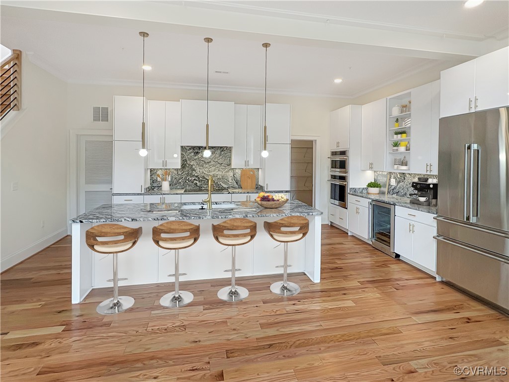 3215 Stuart Avenue, Unit 30 Richmond, VA 23221 - Photo 1 of 28 a kitchen with stainless steel appliances granite countertop a stove a refrigerator and a wooden cabinets