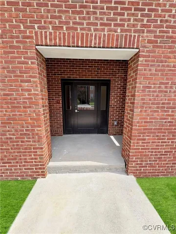 a front view of a house with a garden and garage