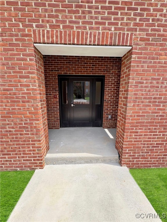3215 Stuart Avenue, Unit 30 Richmond, VA 23221 - Photo 3 of 28 a front view of a house with a garden and garage