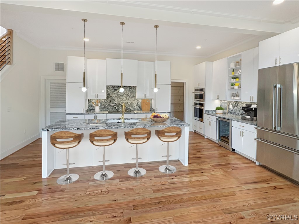 3215 Stuart Avenue, Unit 30 Richmond, VA 23221 - Photo 7 of 28 a kitchen with stainless steel appliances granite countertop a stove a refrigerator and a wooden cabinets
