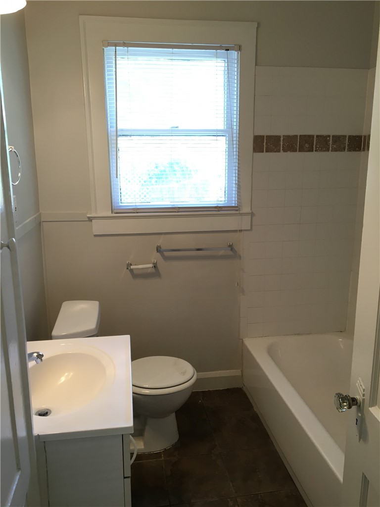 812 East 30th Street Austin, TX 78705 - Photo 11 of 16 a white toilet sitting next to a bath tub