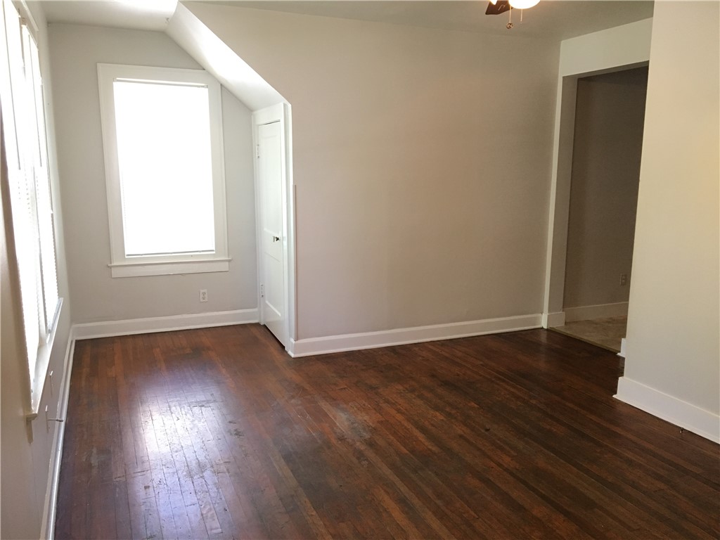 812 East 30th Street Austin, TX 78705 - Photo 9 of 16 an empty room with wooden floor and windows