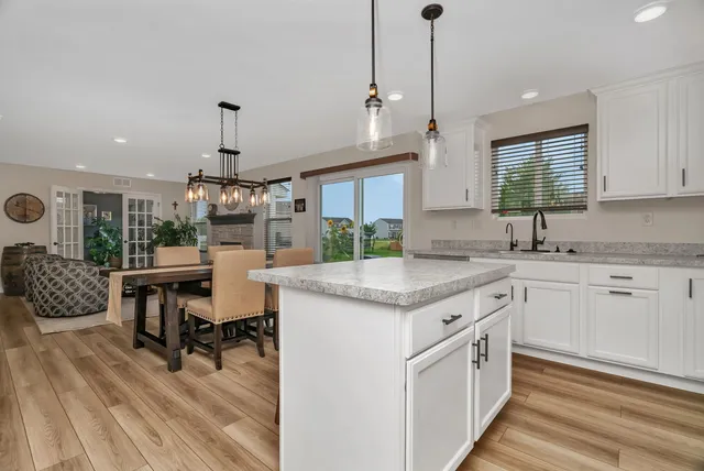 a kitchen with a sink cabinets and wooden floor