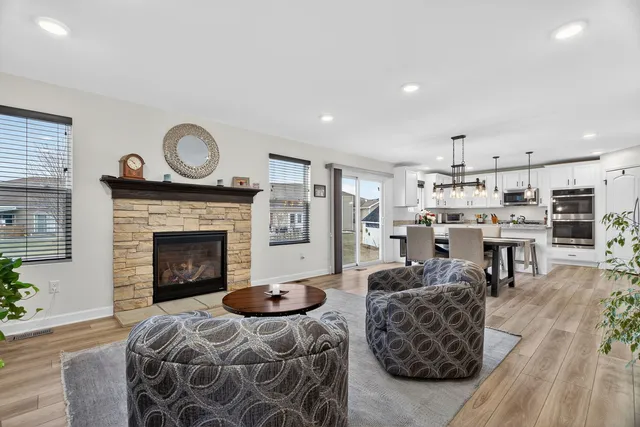 a living room with furniture a fireplace and wooden floor