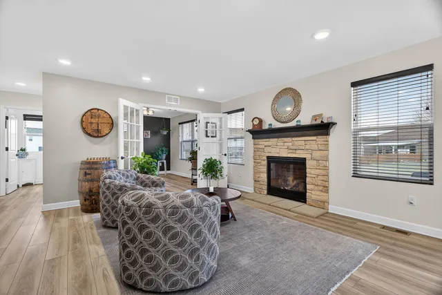 a living room with furniture a window and a fireplace