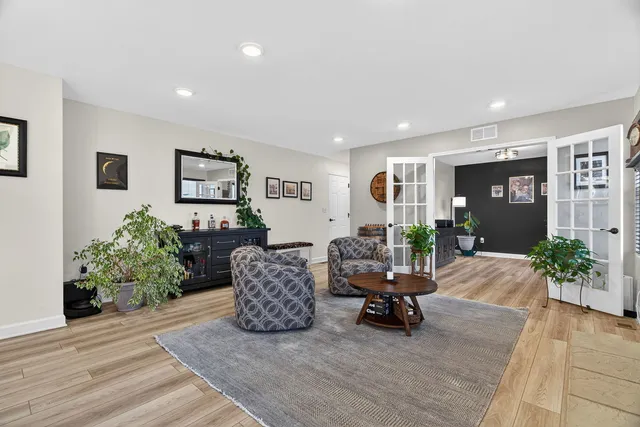 a living room with furniture and a potted plant