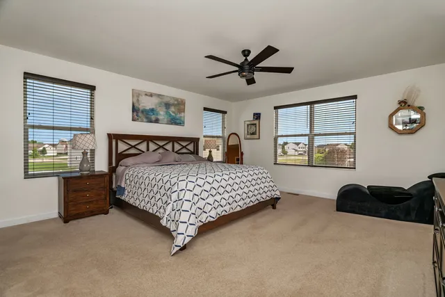 a bedroom with a large bed and a window