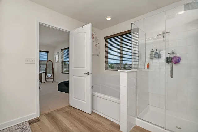 a bathroom with a bathtub and shower