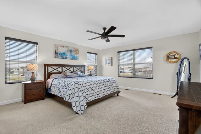 a bedroom with a bed dresser and a window