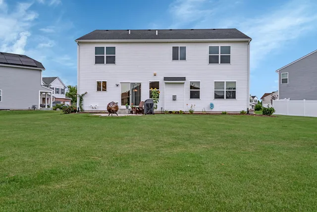a front view of a house with a yard and sitting area