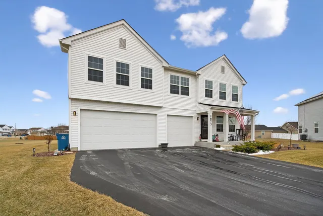 a view of a white house with a yard