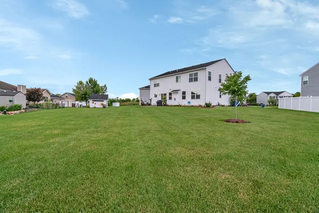a backyard of a house with table and chairs