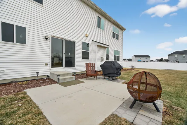 a view of a house with backyard and sitting area