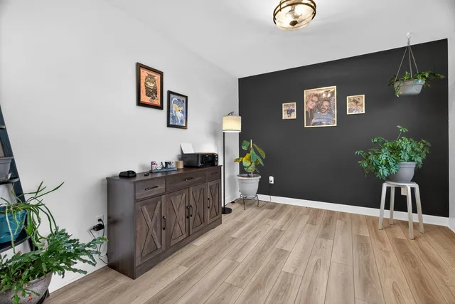 a view of a workspace with furniture and wooden floor