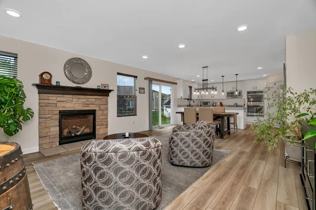 a living room with furniture a fireplace a rug and a fireplace