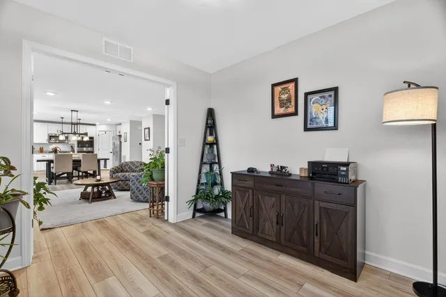 a view of a workspace with furniture and wooden floor