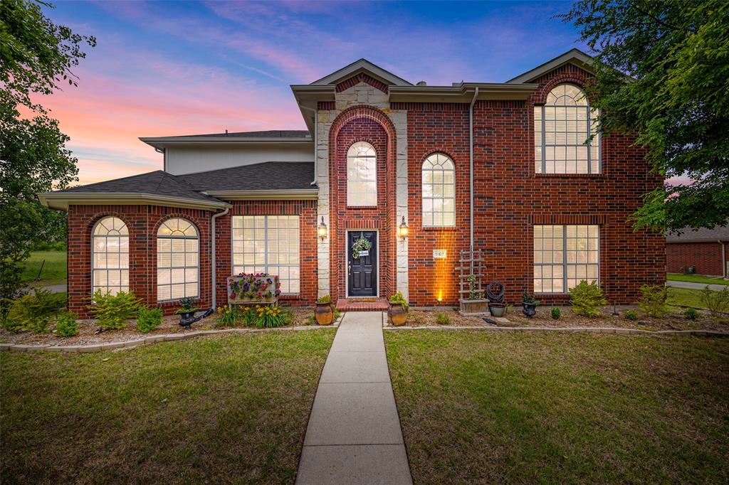 a front view of a house with a garden