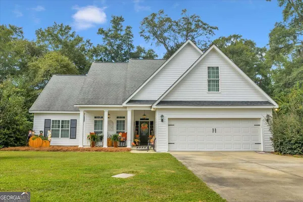 a front view of a house with a garden and yard