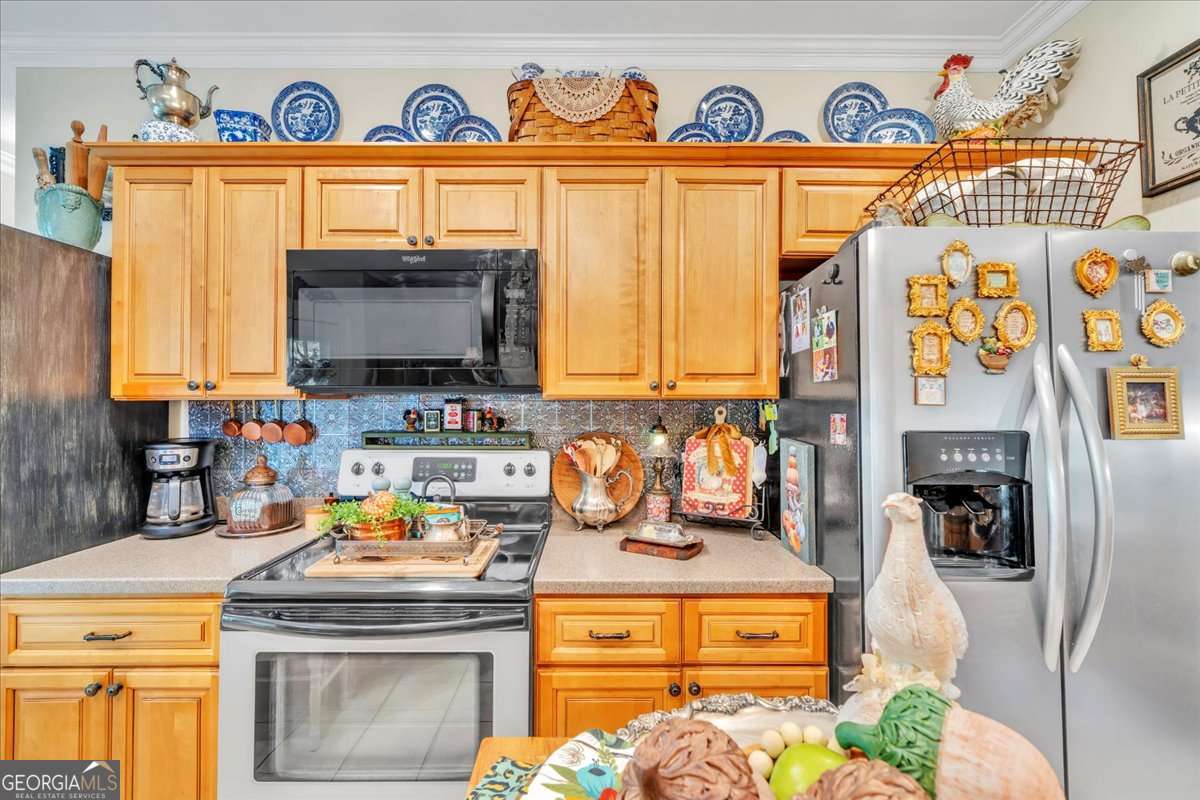153 Landing Road Cordele, GA 31015 - Photo 13 of 62 a kitchen with stainless steel appliances granite countertop a stove and a microwave