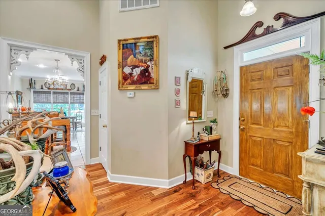a bathroom with a sink mirror and a painting on the wall