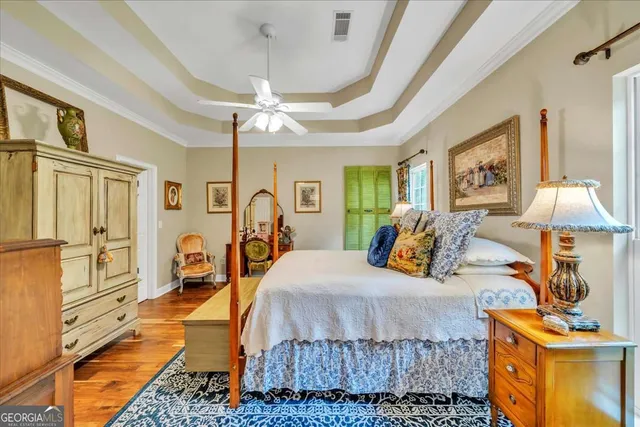 a bedroom with furniture and wooden floor