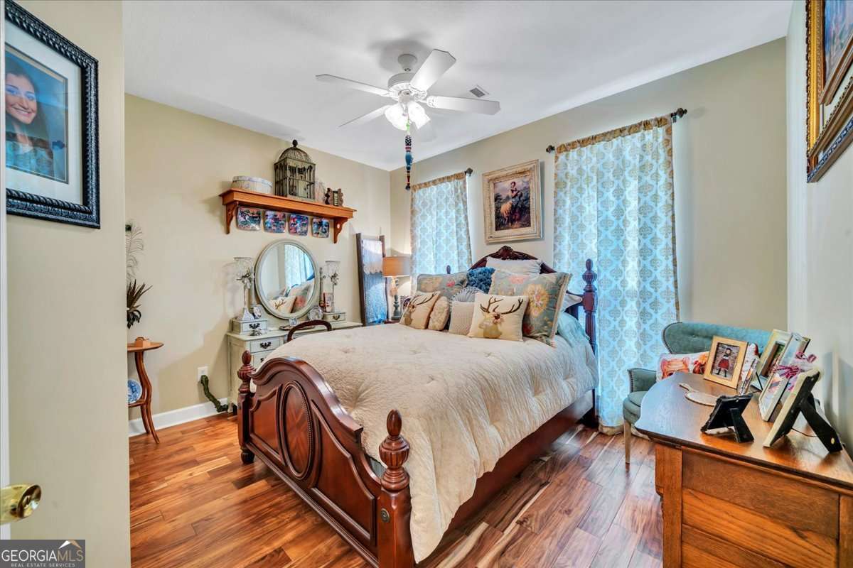 153 Landing Road Cordele, GA 31015 - Photo 27 of 62 a bed room with a bed and a chandelier