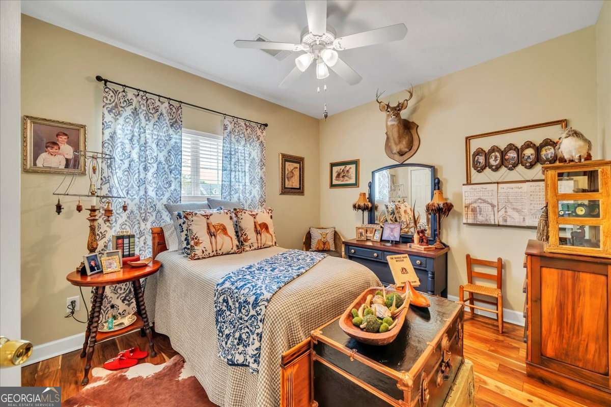 153 Landing Road Cordele, GA 31015 - Photo 29 of 62 a bedroom with furniture and wooden floor