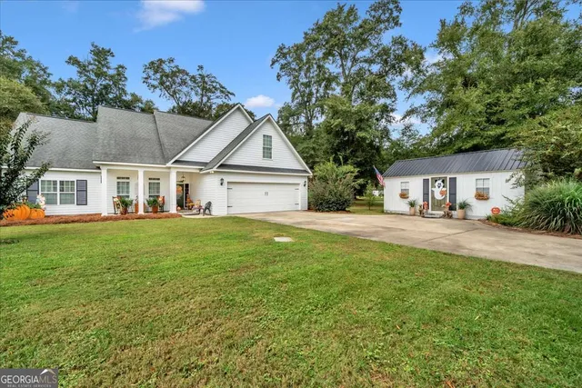a front view of a house with a garden