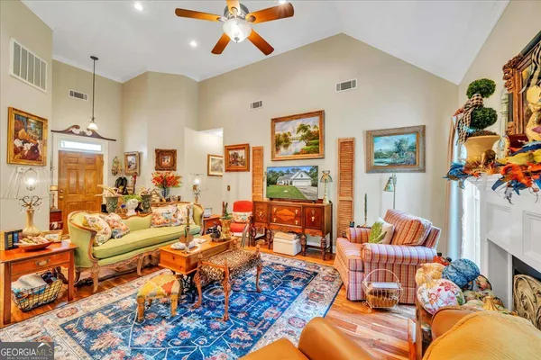 a living room with furniture fireplace and a large window