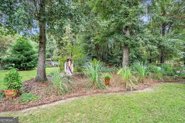 an aerial view of a house with a big yard