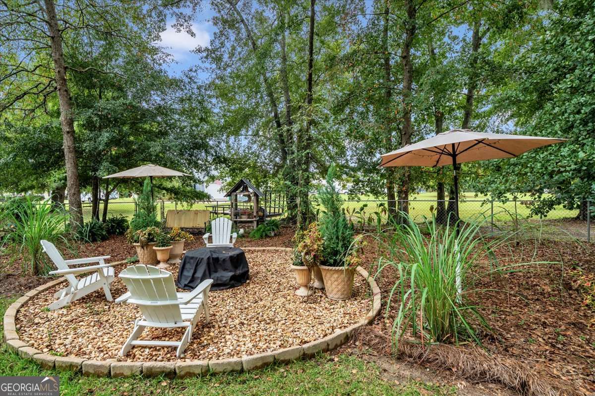 153 Landing Road Cordele, GA 31015 - Photo 43 of 62 a view of a house with backyard fountain and sitting area