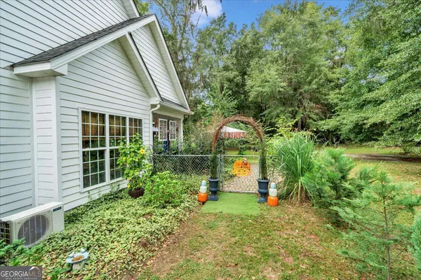 a view of a house with a small yard and plants