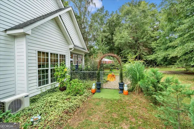 a view of a house with a small yard and plants