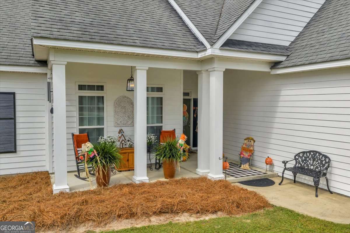 153 Landing Road Cordele, GA 31015 - Photo 55 of 62 a view of a porch with chairs and potted plants