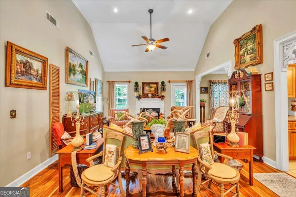 a kitchen with stainless steel appliances granite countertop a stove a sink dishwasher and cabinets with wooden floor