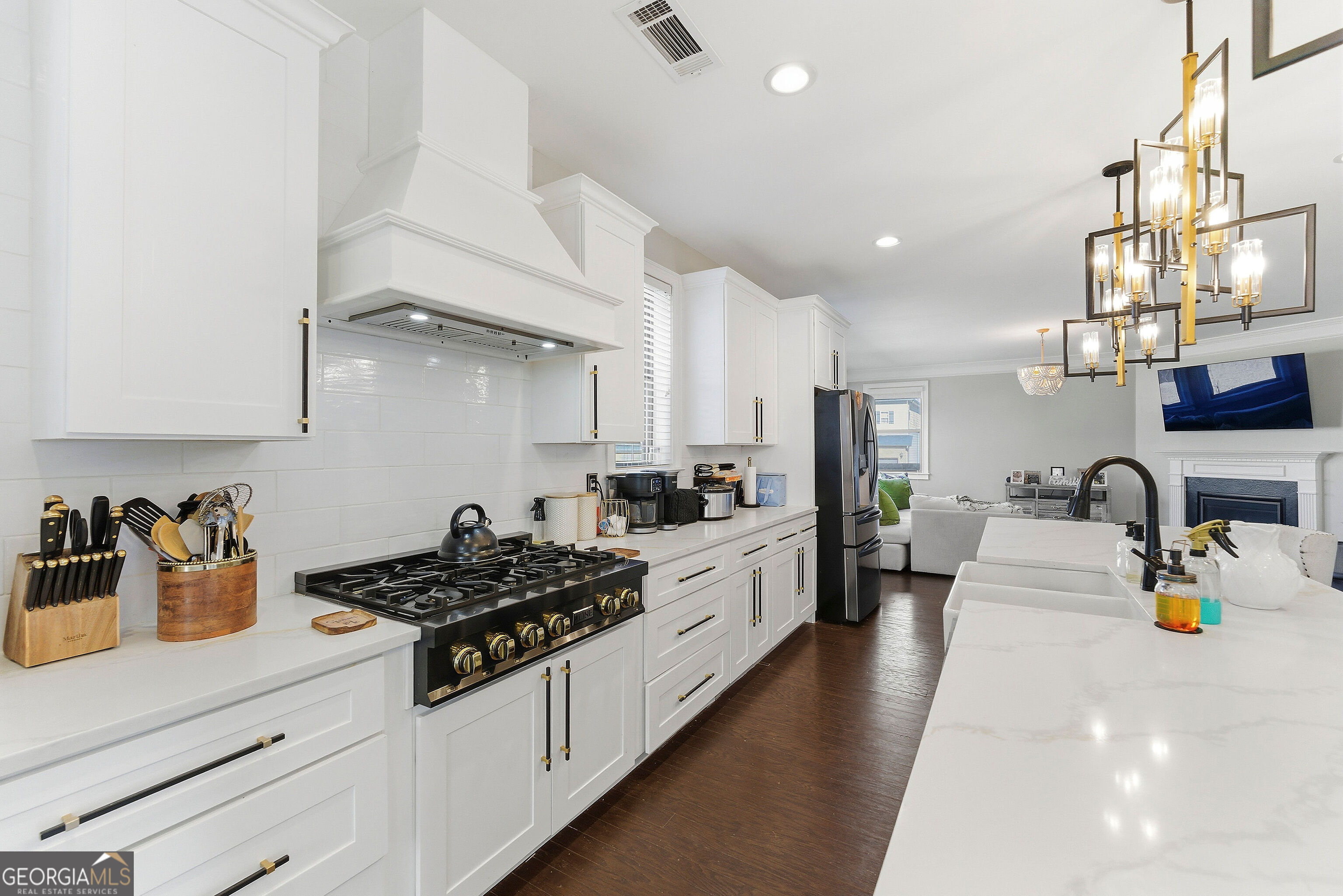 301 Lowell Street Atlanta, GA 30331 - Photo 24 of 28 a kitchen with stainless steel appliances a white stove top oven a sink a counter space and cabinets