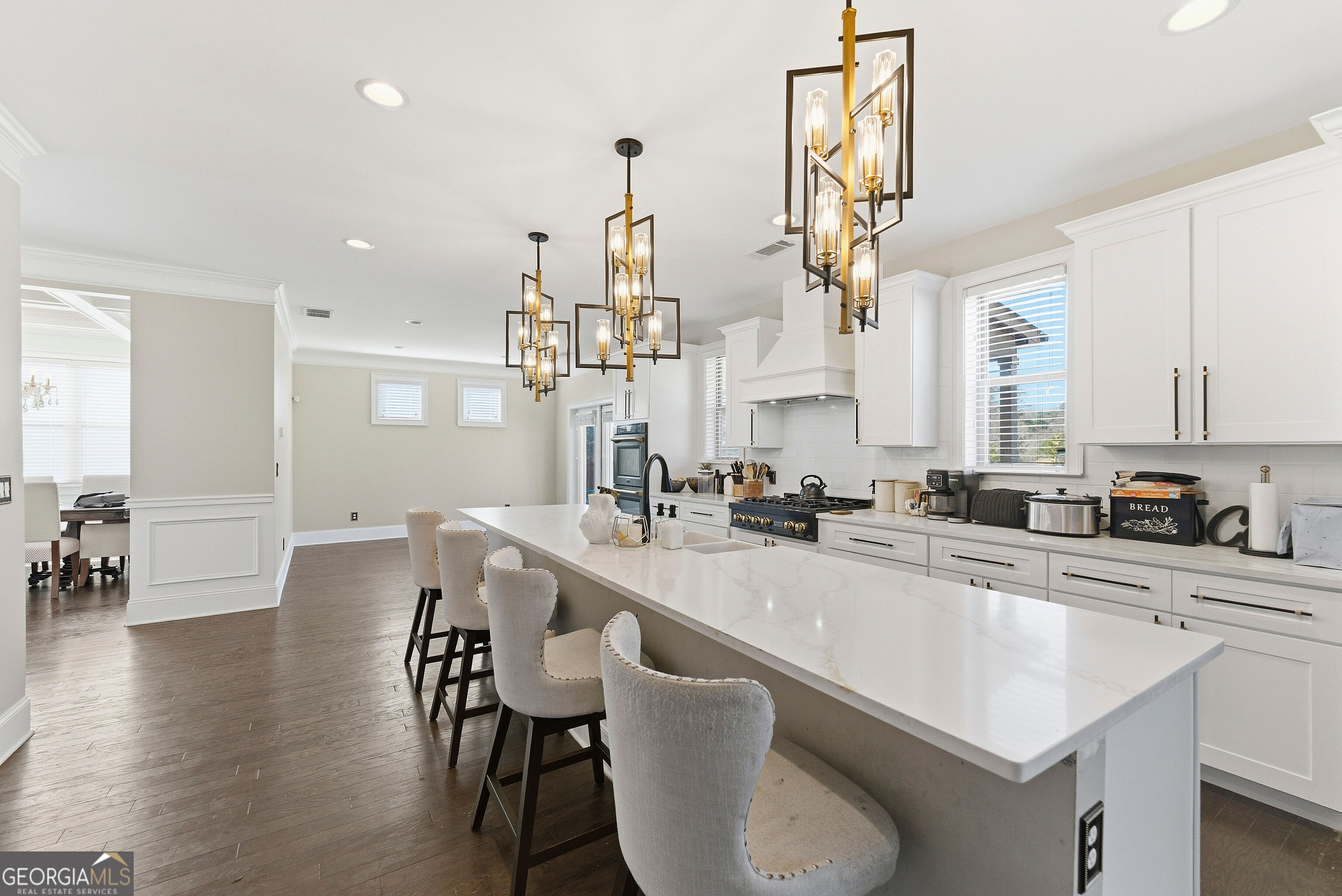 301 Lowell Street Atlanta, GA 30331 - Photo 25 of 28 a kitchen with stainless steel appliances a table chairs sink and cabinets