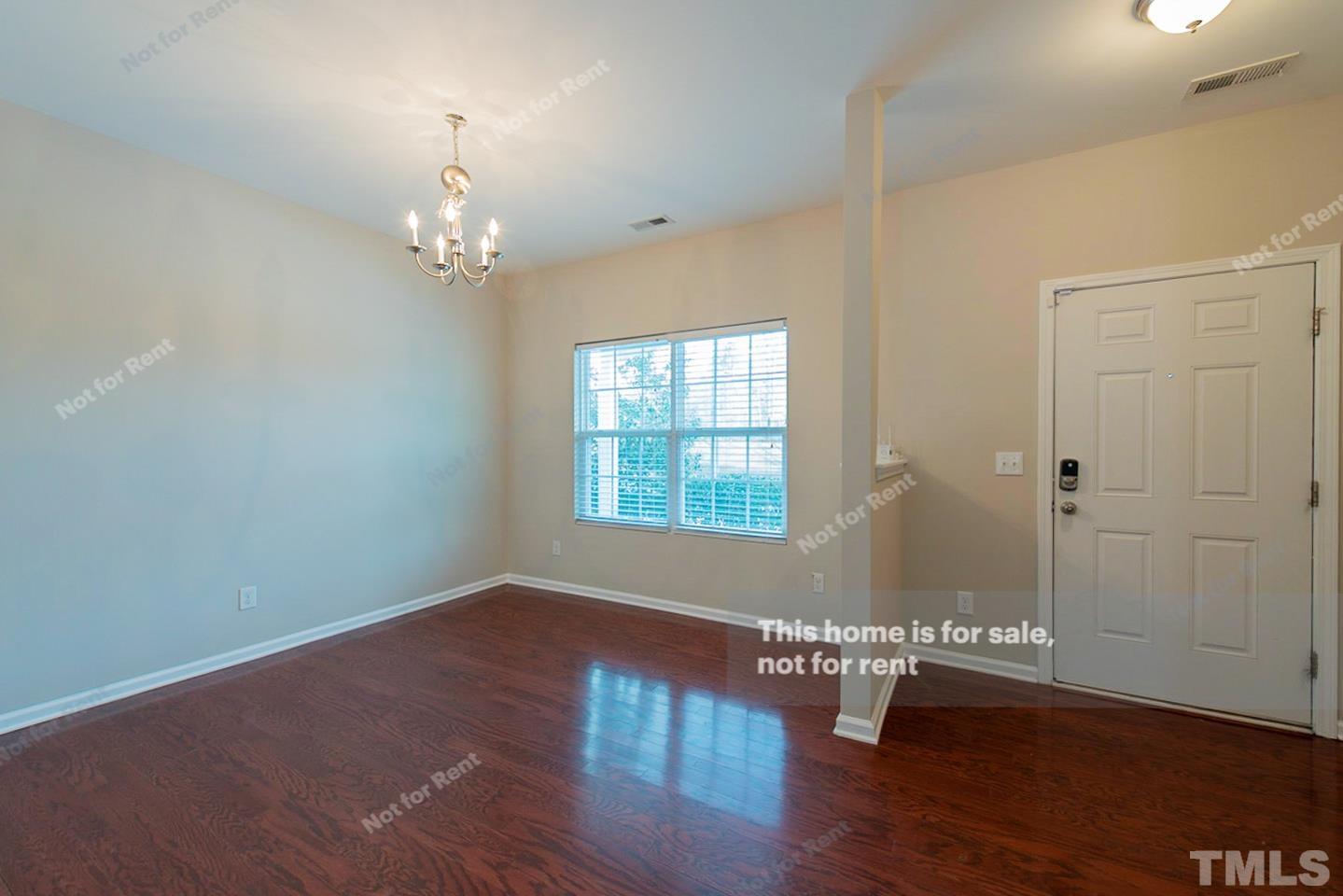 6328 Bunker Hill Drive Raleigh, NC 27610 - Photo 12 of 22 an empty room with wooden floor and windows