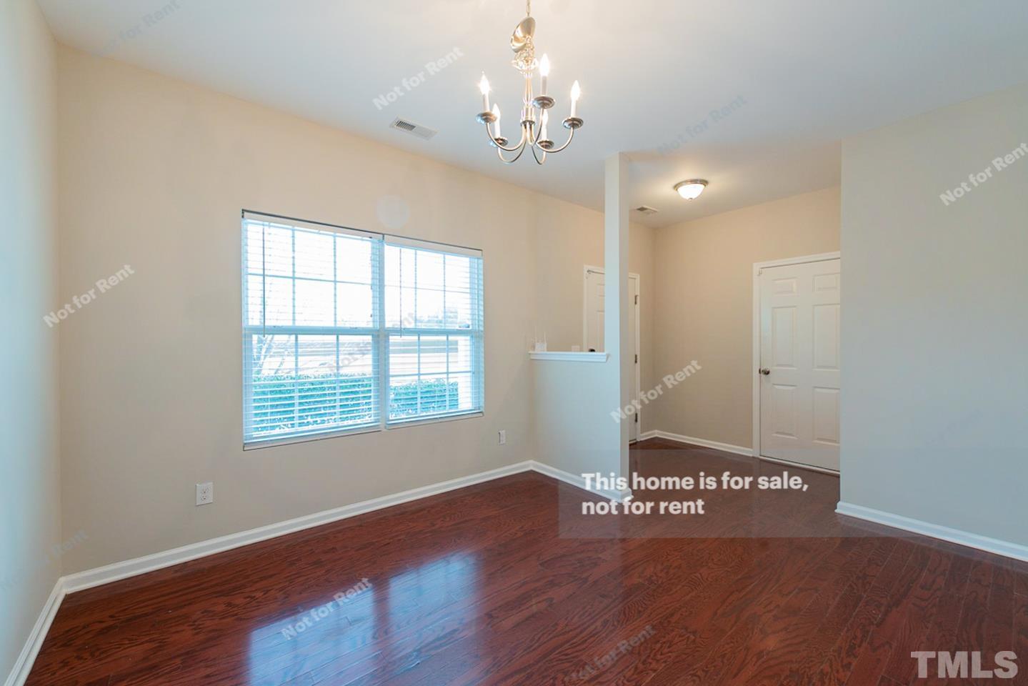 6328 Bunker Hill Drive Raleigh, NC 27610 - Photo 13 of 22 a view of an empty room with wooden floor and a window