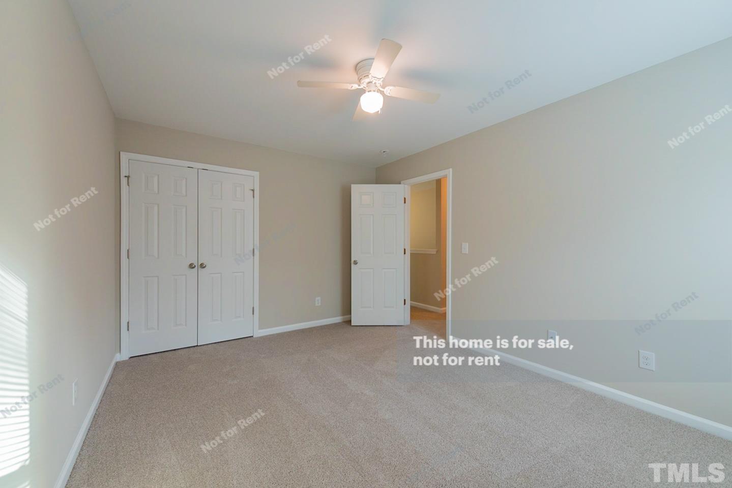 6328 Bunker Hill Drive Raleigh, NC 27610 - Photo 17 of 22 a view of a room with a ceiling fan and window