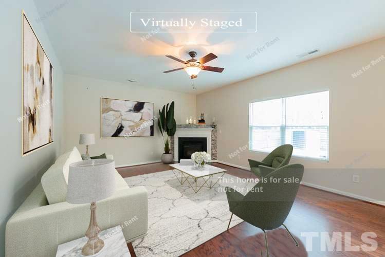 6328 Bunker Hill Drive Raleigh, NC 27610 - Photo 2 of 22 a living room with furniture a fireplace and a large window