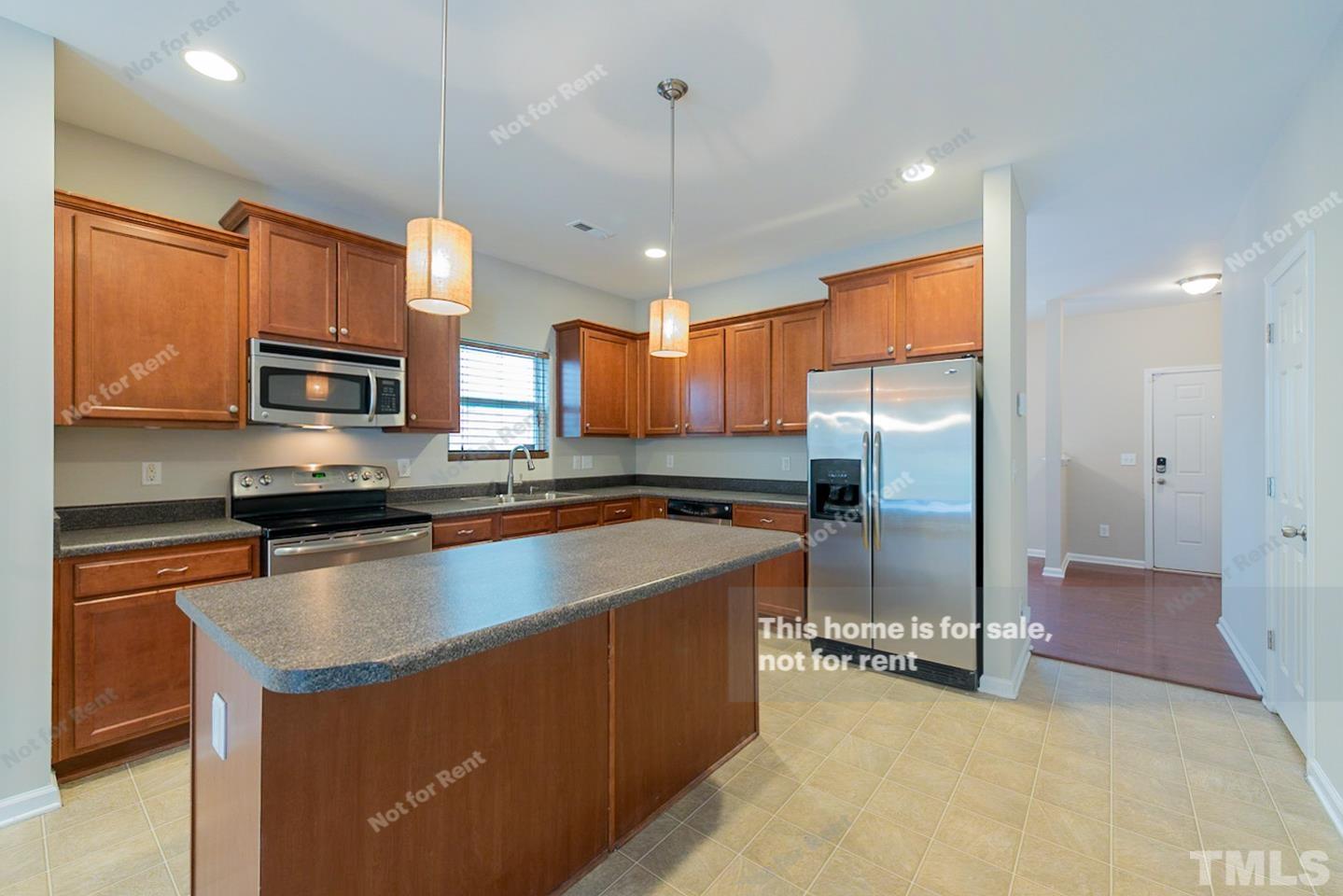 6328 Bunker Hill Drive Raleigh, NC 27610 - Photo 4 of 22 a kitchen with stainless steel appliances granite countertop a sink refrigerator and microwave