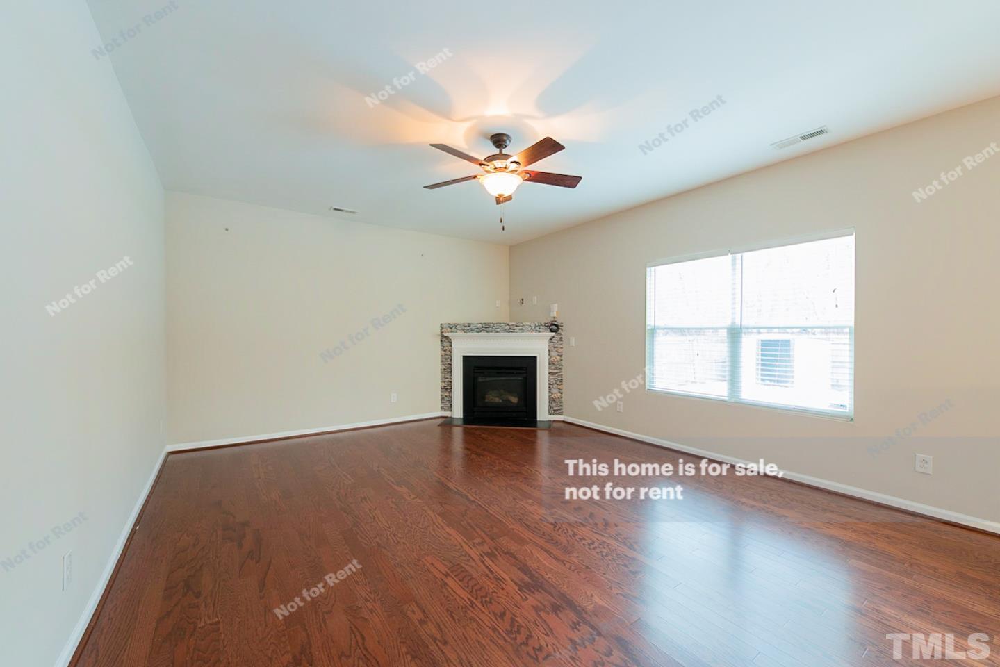 6328 Bunker Hill Drive Raleigh, NC 27610 - Photo 5 of 22 an empty room with windows and a fireplace