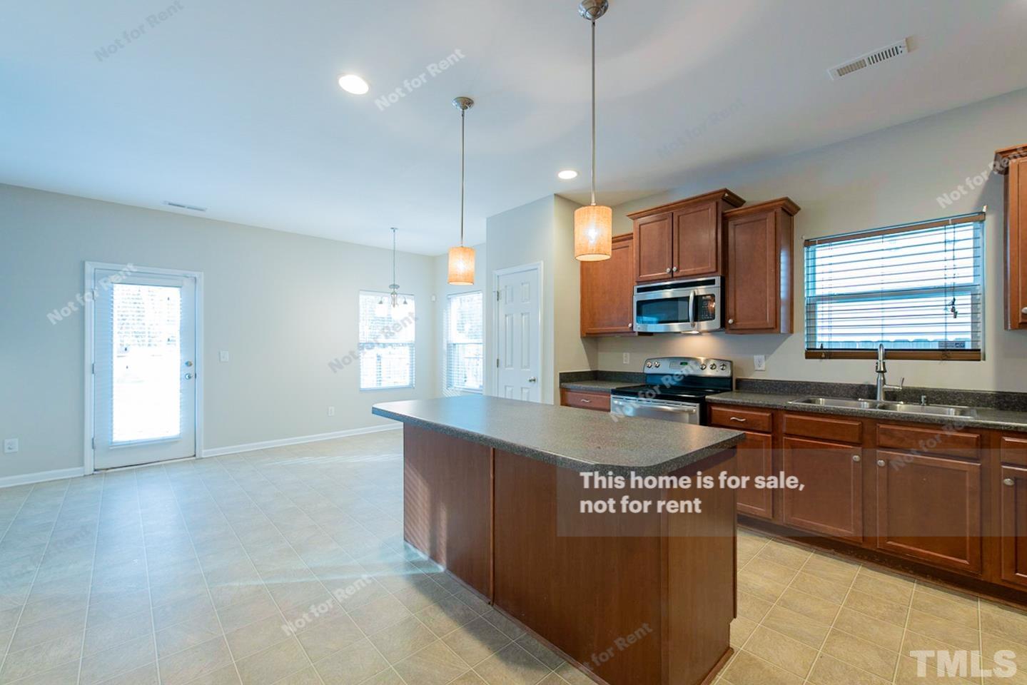6328 Bunker Hill Drive Raleigh, NC 27610 - Photo 8 of 22 a kitchen with stainless steel appliances granite countertop a sink a stove and a wooden floors