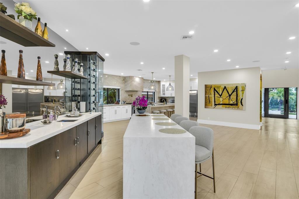 319 South Riverside Drive Pompano Beach, FL 33062 - Photo 13 of 88 a view of a kitchen with kitchen island stainless steel appliances a sink and counter top space