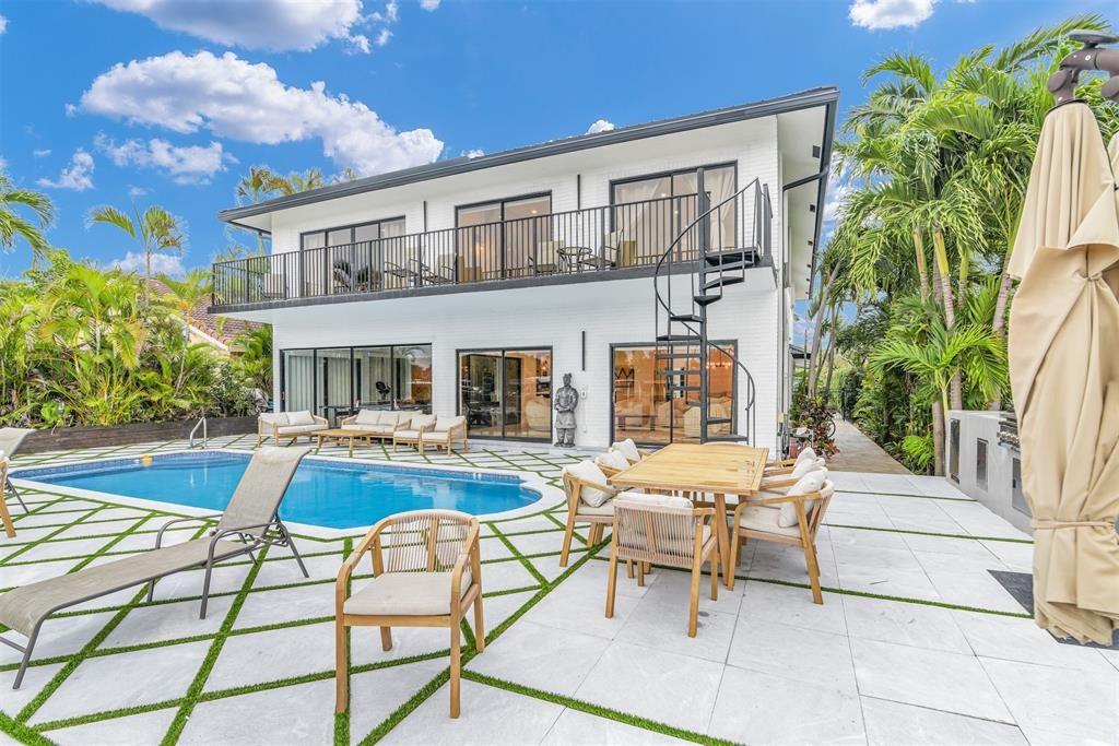 319 South Riverside Drive Pompano Beach, FL 33062 - Photo 23 of 88 a view of a house with swimming pool and sitting area