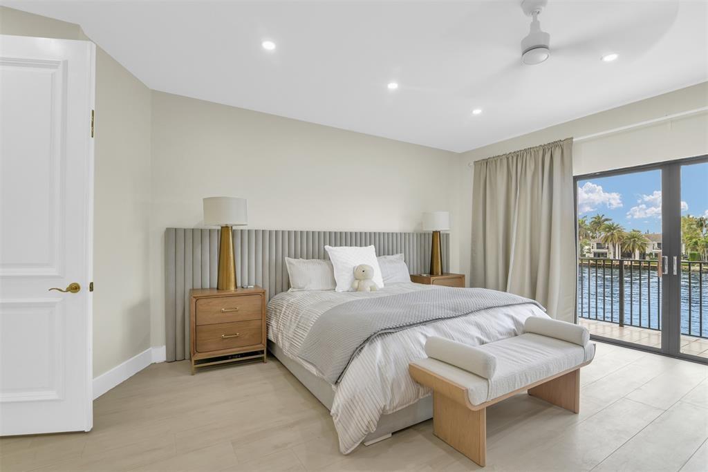 319 South Riverside Drive Pompano Beach, FL 33062 - Photo 37 of 88 a bedroom with a bed and a large window