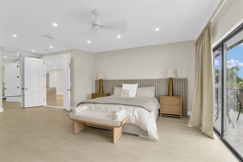 319 South Riverside Drive Pompano Beach, FL 33062 - Photo 38 of 88 a spacious bedroom with a bed and a large window